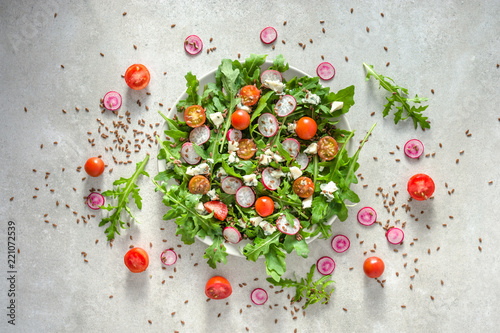 Healthy vegetable salad with fresh vegetables, vegetarian food on plate, top view