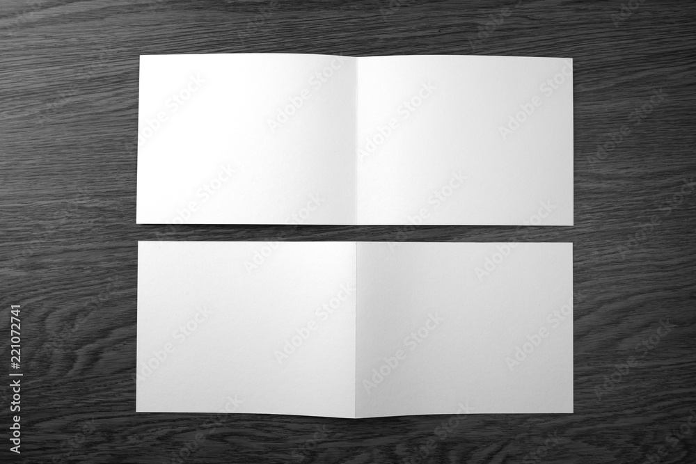 Mockup of white booklet on wooden background. Mockup of white booklet on wooden background.