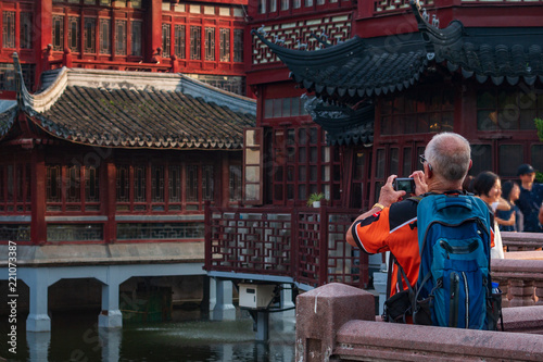 Tourist take a photo in popular famous tourist place of Yuyuan garden old Shanghai
