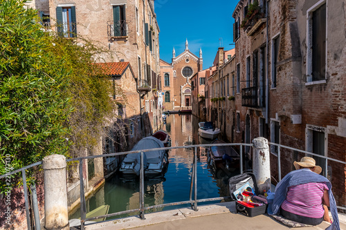 VENICE, ITALY, CANAL - A view from a bridge into a narrow side canal, to the Roman Catholic church Madonna dell'Orto. A gothic building. © Copula