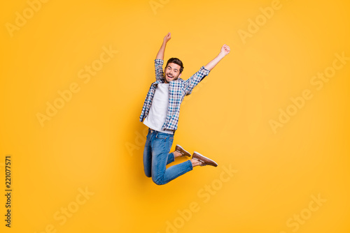 Full-size portrait of happy excited young man screaming and jump