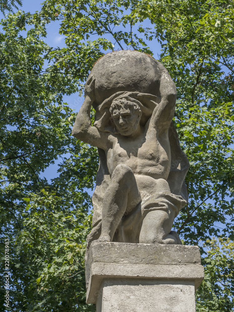 Stone men figure carrying stone, baroque statue from Greek mythology of Sisyphus or Sisyphos
