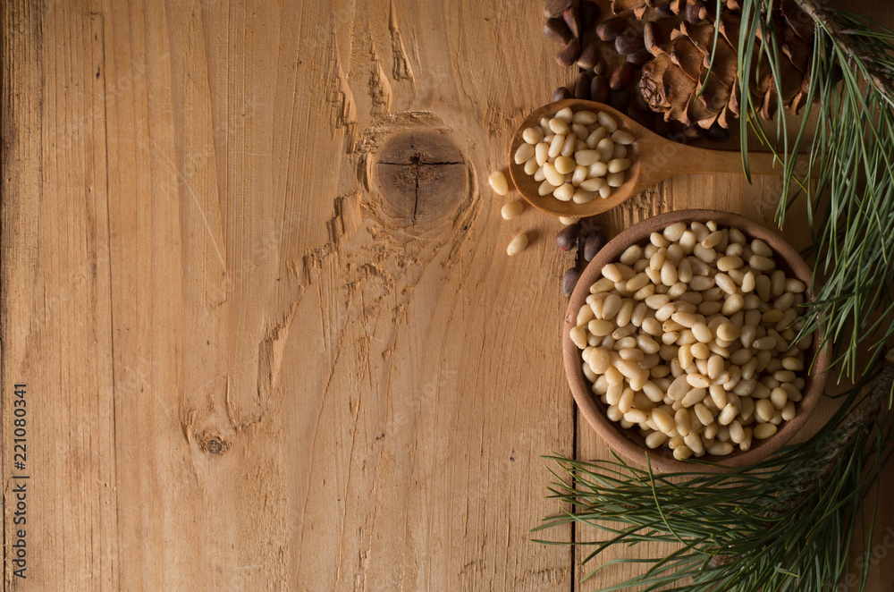 Cedar nuts and cones on wooden table Cedar nuts and cones on wooden table