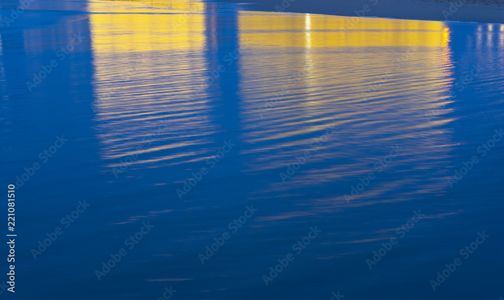 Fototapeta premium SAN SEBASTIAN, SPAIN - SEPTEMBER 04, 2018: Auditorium reflected in the water of the beach where the San Sebastian film festival is held
