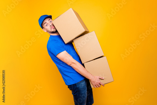 Handsome attractive tired bearded deliver on-time guy in blue un photo