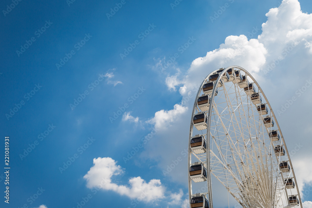 White big Ferris wheel  with blue sky sharp clouds