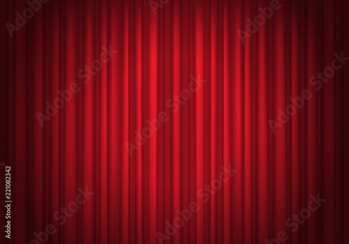 Red curtains background illuminated by a beam of spotlight