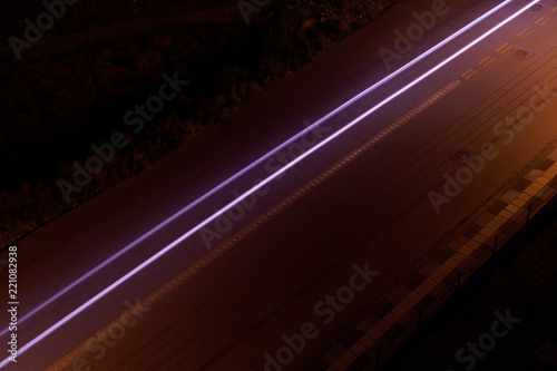 Long exposure of car , which is passing through street.