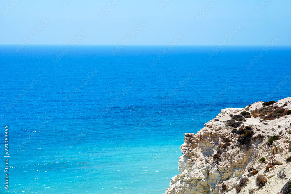 Beautiful seascape with a cliff over sea in sunny summer day not far from the city of Paphos in Cyprus Beautiful seascape with a cliff over sea in sunny summer day not far from the city of Paphos in Cyprus