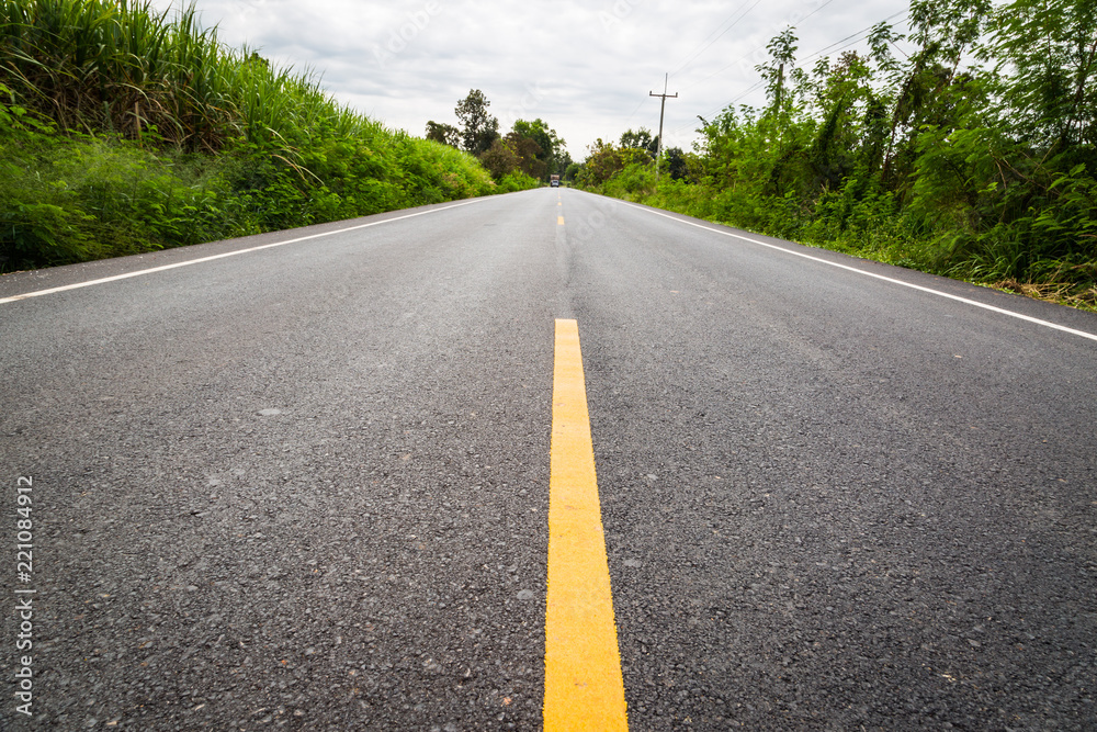 Empty asphalt road through the agricultural fields Empty asphalt road through the agricultural fields