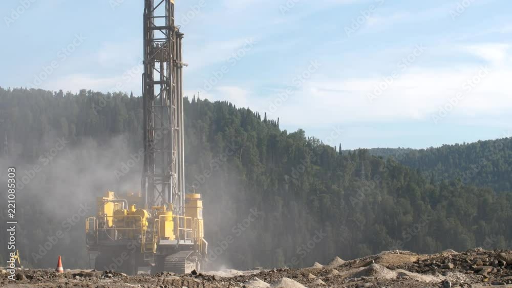 Drilling rig in the coal open pit. Drilling holes for explosives in the quarry. Slow motion, 4k, 60fps