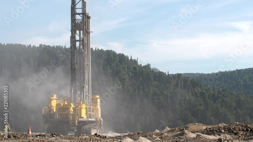 Drilling rig in the coal open pit. Drilling holes for explosives in the quarry. Slow motion, 4k, 60fps