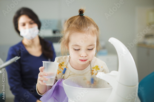 Child rinses out mouth and spit in special sink