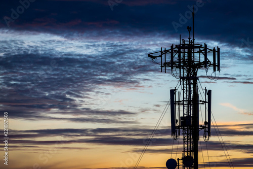 Silhouette  communication tower poles on sunset photo