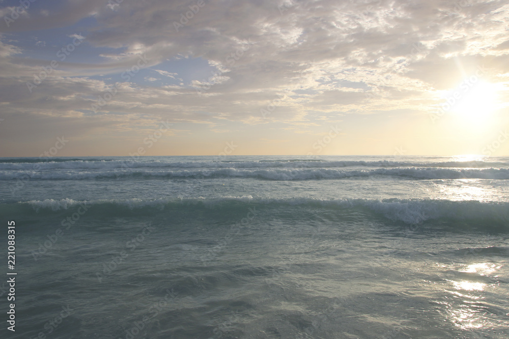 Beautiful sunset on Karon beach. The surf pounds the shore. Phuket, Thailand