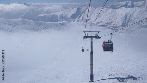 ski lift over clouds in snowy mountains of Georgia