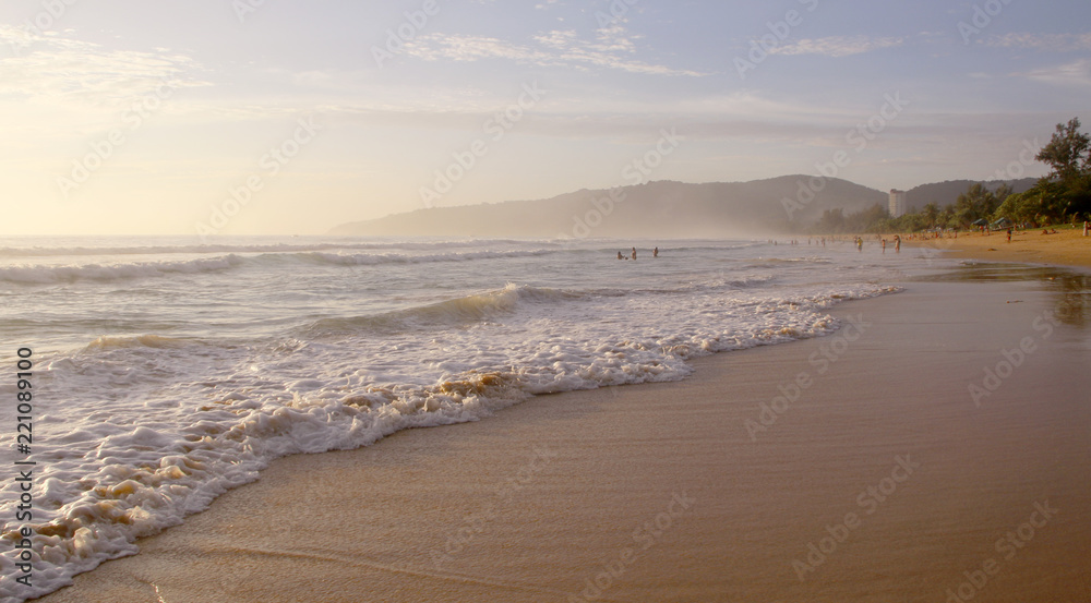 Beautiful sunset on Karon beach. The surf pounds the shore. Phuket, Thailand Beautiful sunset on Karon beach. The surf pounds the shore. Phuket, Thailand