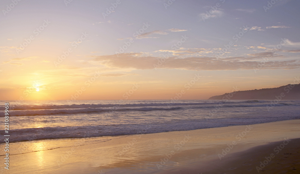 Beautiful sunset on Karon beach. The surf pounds the shore. Phuket, Thailand