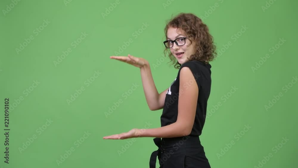 Young happy beautiful nerd woman snapping fingers and showing something Young happy beautiful nerd woman snapping fingers and showing something
