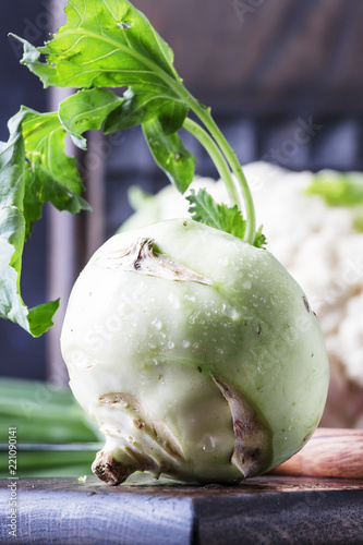 Green kohlrabi cabbage, auatumn harvest on brown table. selective focus photo