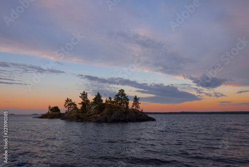 View on island in sea and sky with dark clouds © pavel_812