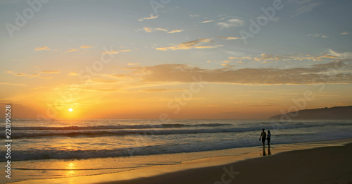 Beautiful sunset on Karon beach. The surf pounds the shore. Phuket, Thailand