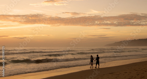 Beautiful sunset on Karon beach. The surf pounds the shore. Phuket, Thailand