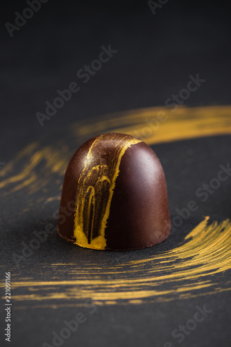 Luxury bonbons painted with gold on black background