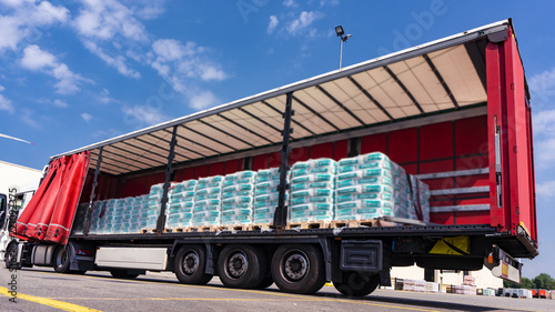 There is a loading to the truck trailer . Truck Trailer  . Cargo Transportation . Lorry horizontal .  Concept of wholesale  . fastening of freight in the trailer . distribution warehouse 