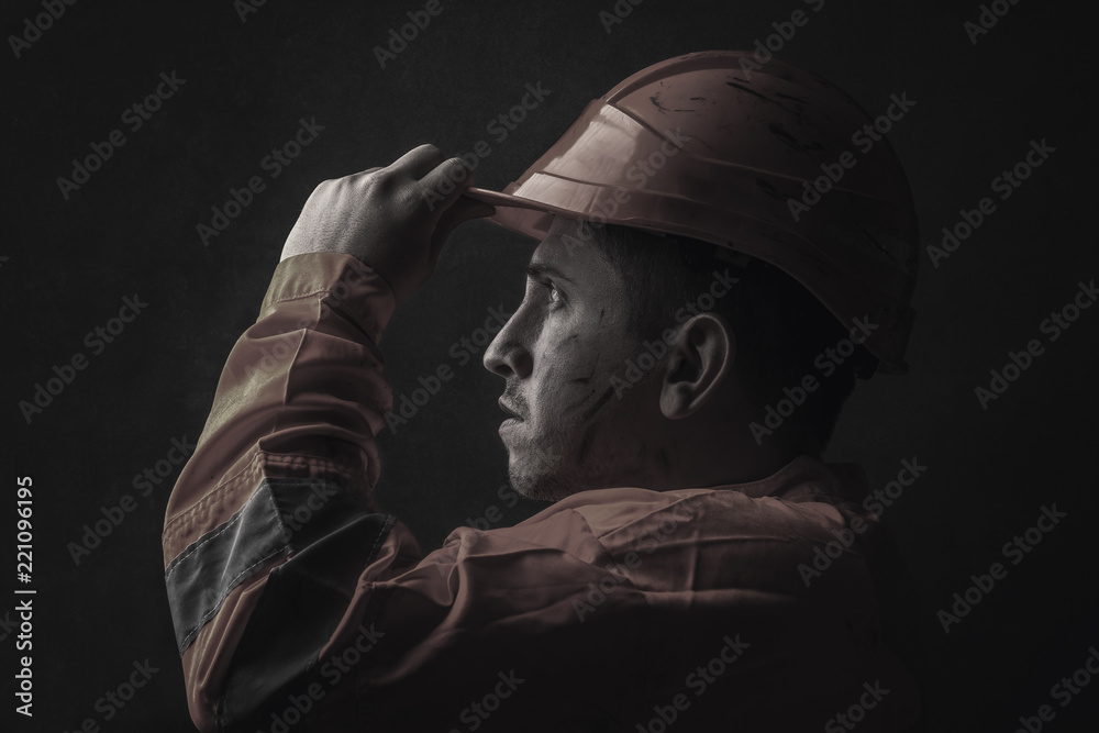 dramatic portrait of tired rail worker who hold his safety helmet - obrazy, fototapety, plakaty 