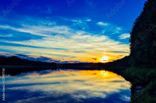 sunset in the clouds over the lake