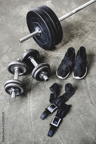 various weight lifting equipment on concrete surface