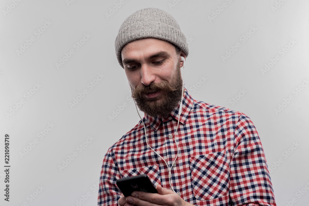 Man with hat. Stylish bearded young businessman wearing grey hat on his head on image without face retouching Man with hat. Stylish bearded young businessman wearing grey hat on his head on image without face retouching