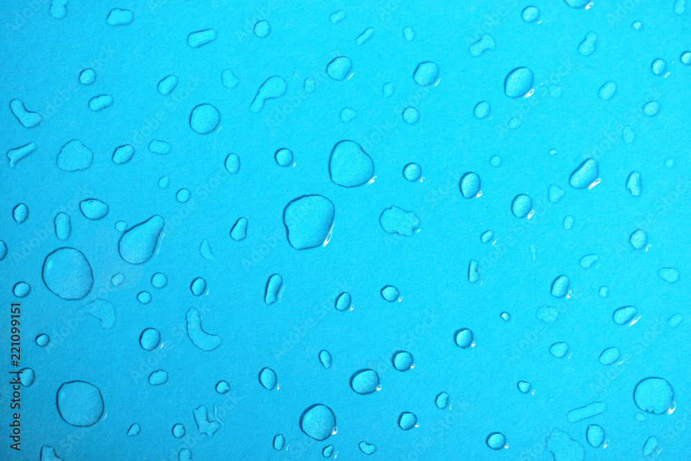 Water drops on blue glass background
