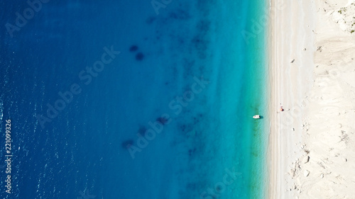Aerial bird's eye view photo taken by drone of tropical white sandy beach with turquoise clear waters and pine trees