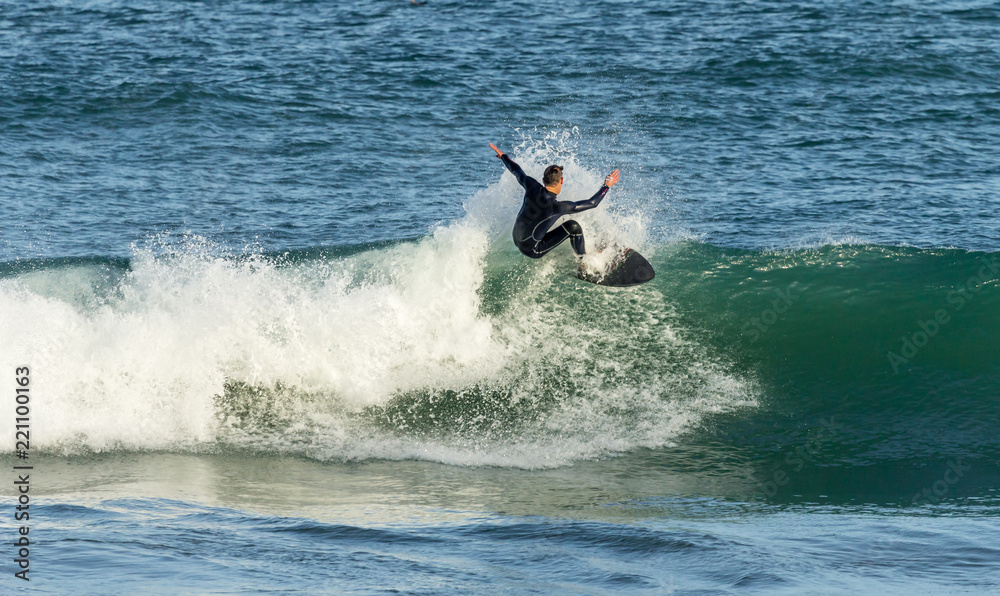 Surfer riding crest of wave, Fistral, Cornwall Surfer riding crest of wave, Fistral, Cornwall