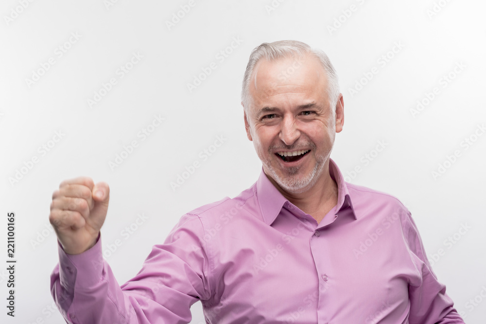 Satisfied man. Image without face retouching with smiling handsome aged man feeling extremely satisfied after business meeting Satisfied man. Image without face retouching with smiling handsome aged man feeling extremely satisfied after business meeting