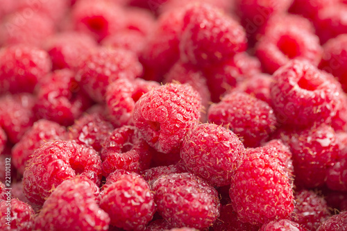 Raspberry fresh and sweet on wooden background close up