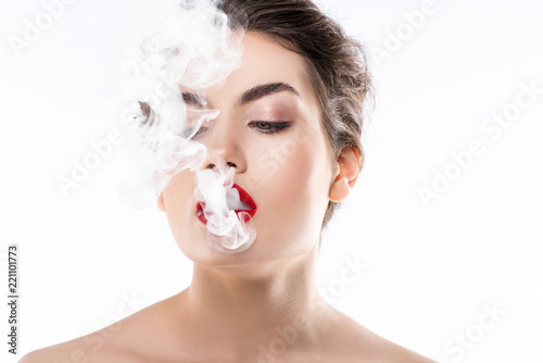 beautiful woman smoking and blowing smoke  isolated on white