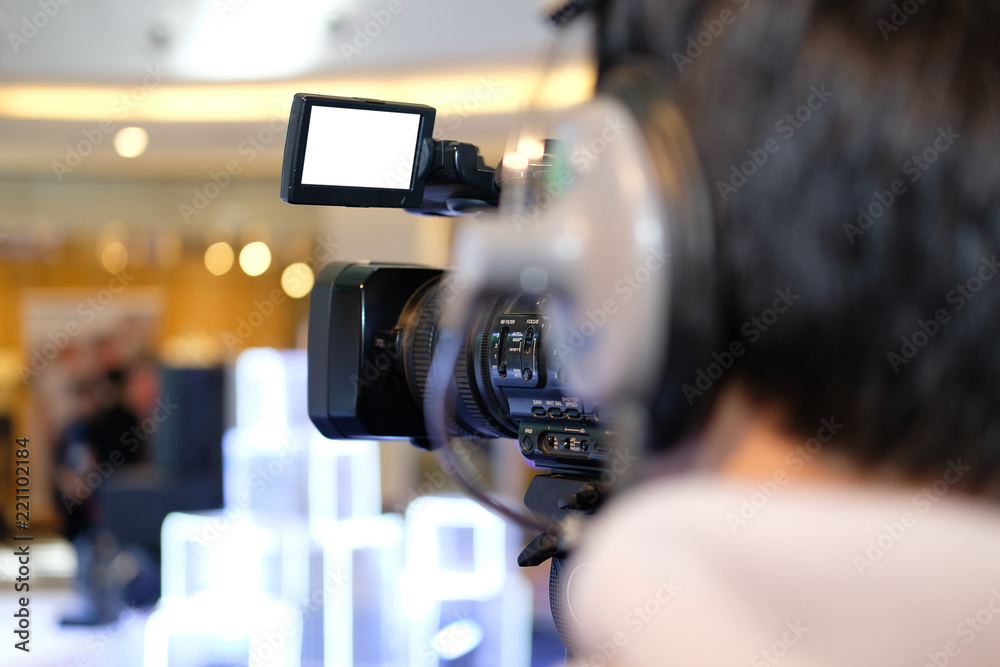 video production camera recording live event on stage. television social media broadcasting seminar conference.