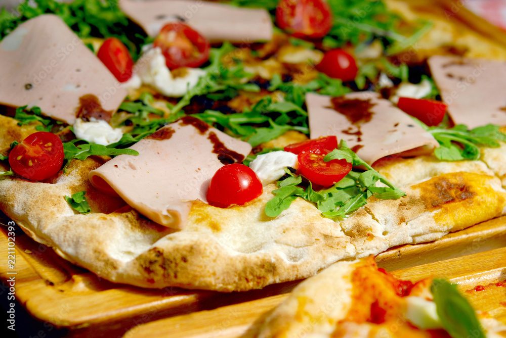 Pizza with sausage on a wooden board