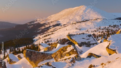 Top of the mountain at sunrise. Ural mountain.Iremel. Majestic landscape glowing by sunlight in the morning. Trackingshot.