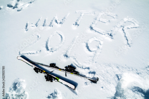 inscription on snow winter 2019 and skis