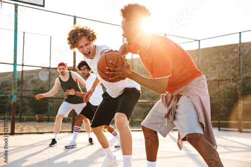 Group of young strong multiethnic men basketball players