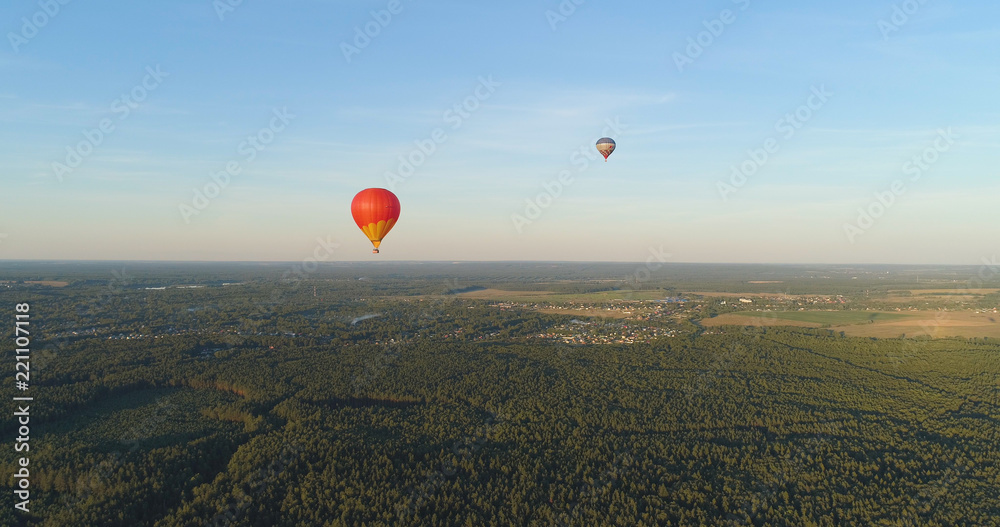 Obraz premium Aerial view Hot air balloons in sky over fields in countryside, beautiful sky and sunset. Aerostat fly over countryside.