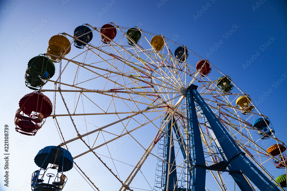 Ferris wheel against the blue sky.