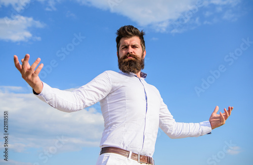 Guy enjoy top achievement. Superiority and power. Man bearded hipster formal clothes feels proud of himself sky background. Self proud feeling. Hipster beard and mustache looks attractive white shirt
