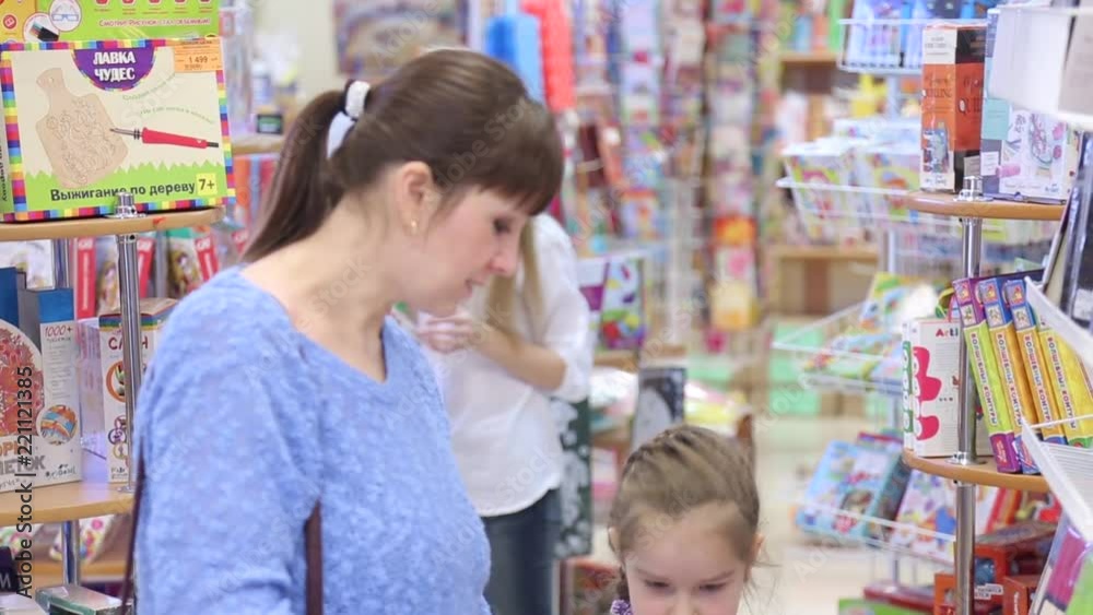 Mom and daughter choose school supplies in the stationery store Mom and daughter choose school supplies in the stationery store
