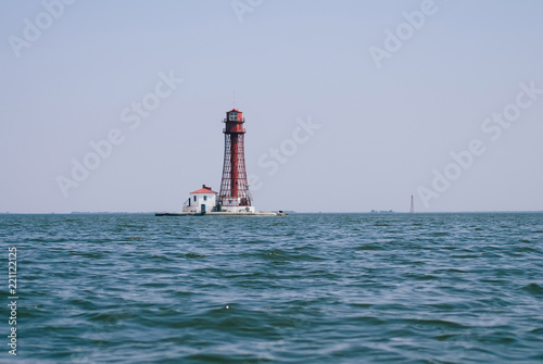 Lighthouse on the water, calm seascape,