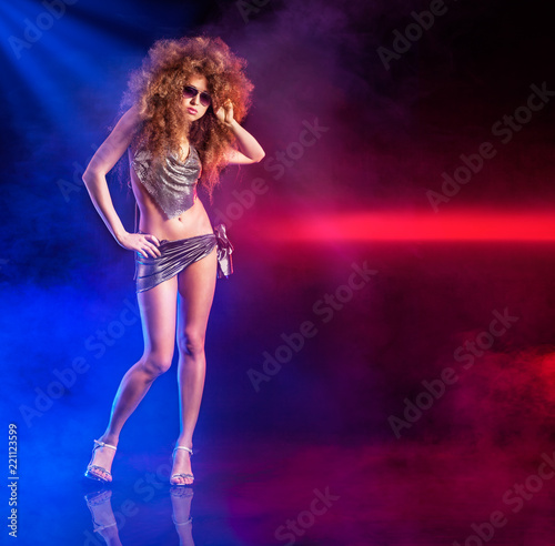 Sexy woman is dancing disco with lights and fog